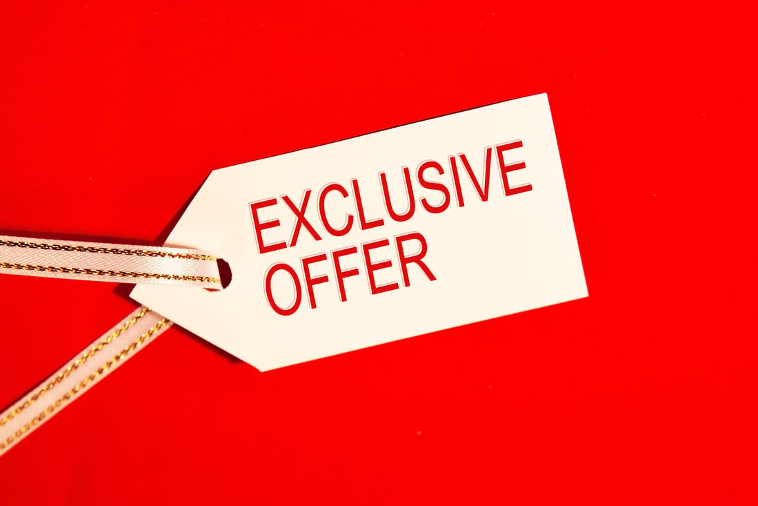 Exclusive offer - text on white label on red background.