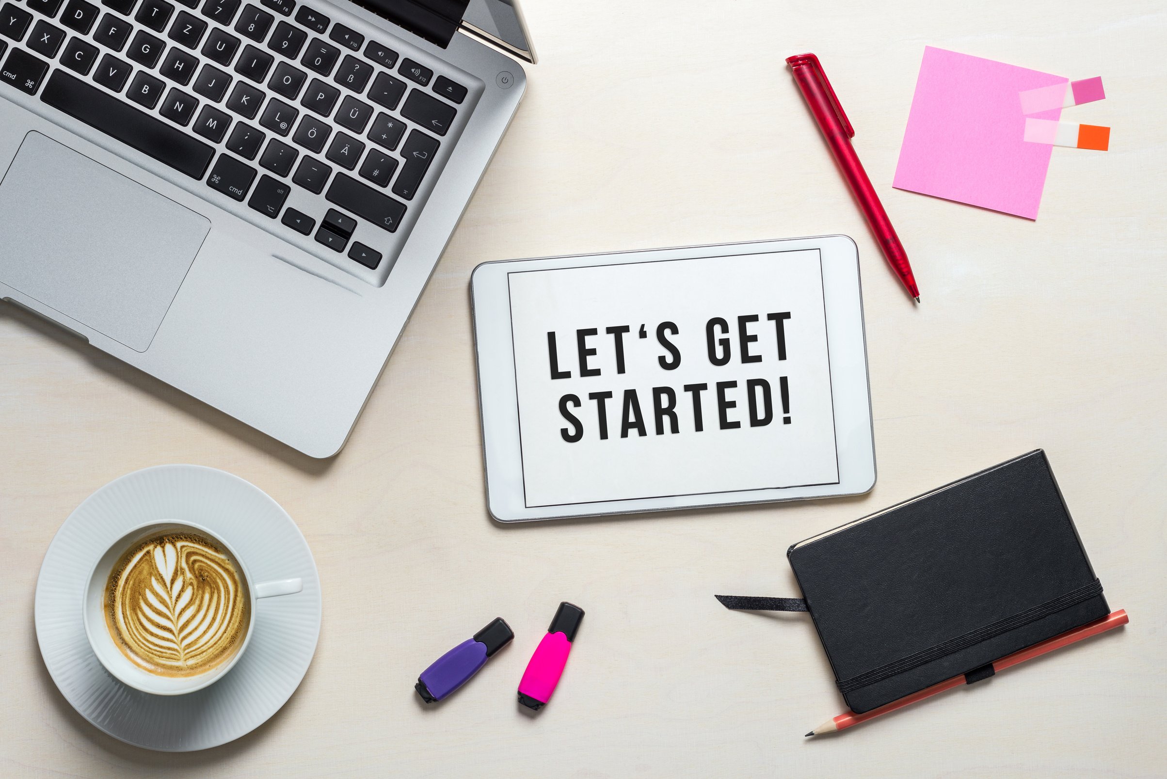 Let's get started written on tablet lying on desk as flatlay