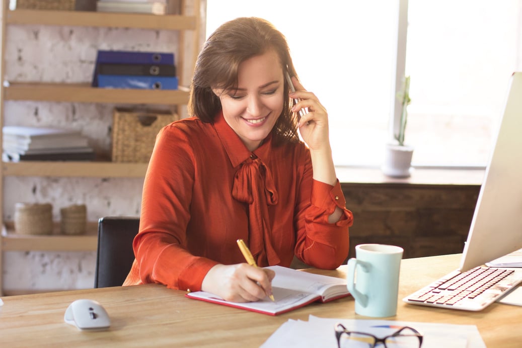 Woman Working with Phone in the Office